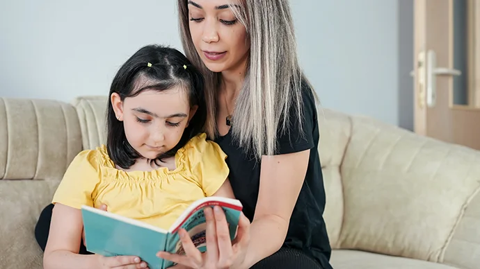 Mother teaching her daughter about finances