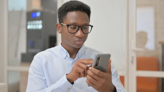 Man looking at scam text message