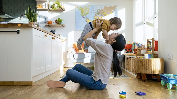 Woman playing with her child inside their house