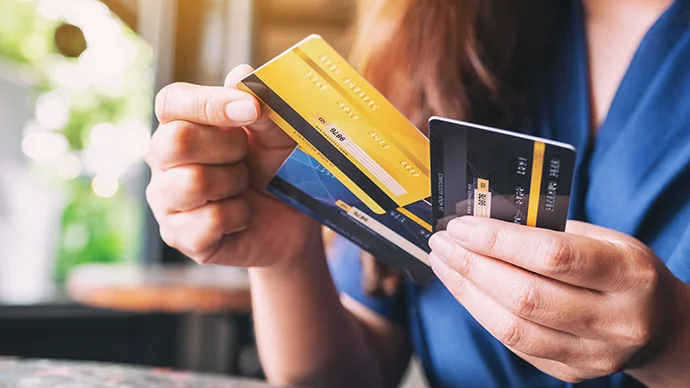 Woman holding several credit cards in her hand