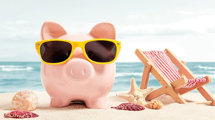 Piggy bank wearing shades while at the beach